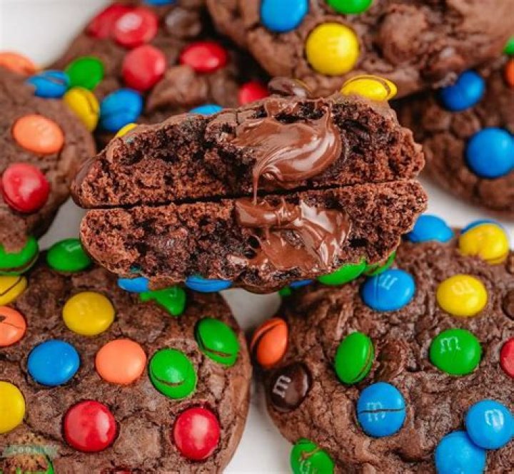 Assembling M&M cookie mix in a jar.