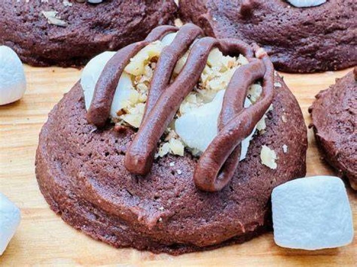 Chocolate cookie topped with marshmallows and nuts.