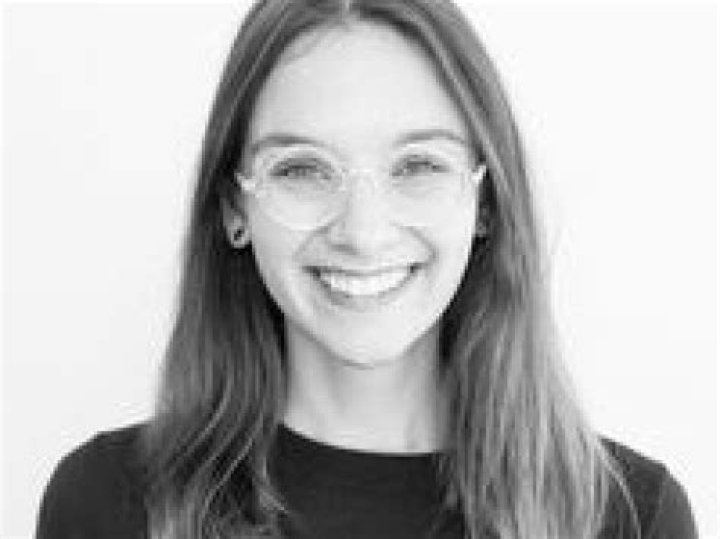 Laina Morris in a boat in red t-shirt alongside pet dog Gilly.