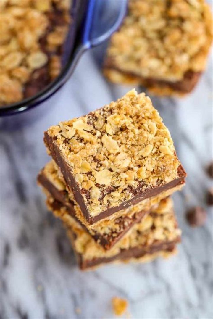 Stack of three Oatmeal Fudge Bars on parchment paper.