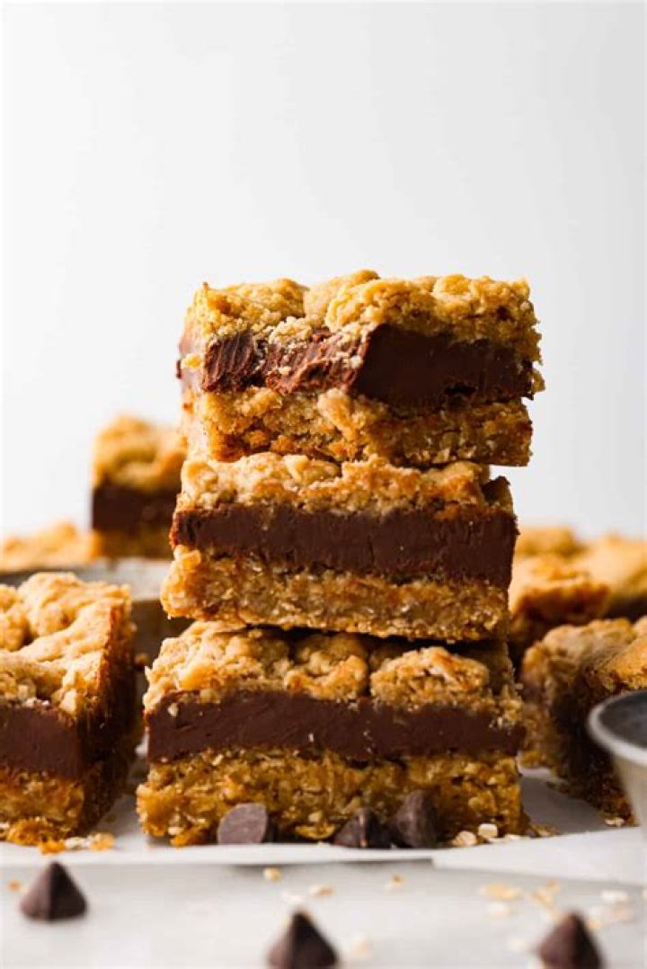 Stack of two Oatmeal Fudge Bars on parchment paper.