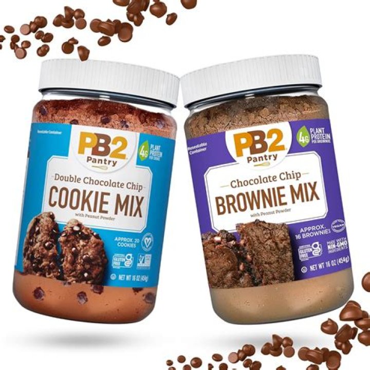 Two jars of cookie mix, one with holiday M&M's the other with chocolate chips.